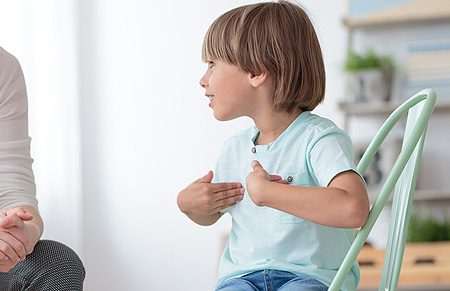 young boy talking to adult