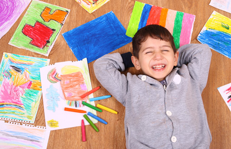 Happy boy with drawings