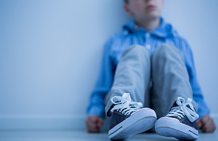 sad boy sitting alone