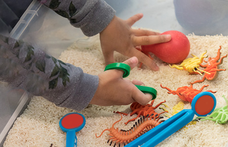 child using a therapy sandbox