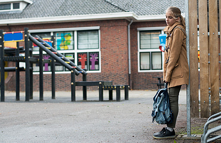 teenage girl alone in vacant schoolyard