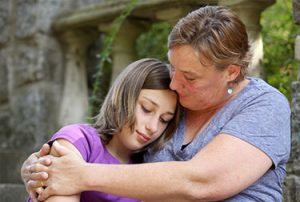 Mom comforting teen