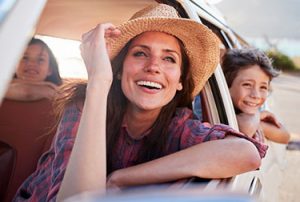 Womand and kids in car having fun