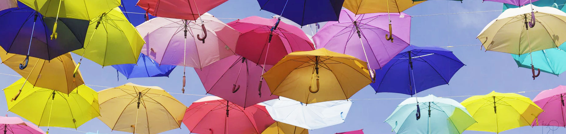 sunny sky full of colorful umbrellas